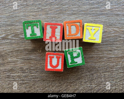 TIDY UP sentence written with wood block letter characters Stock Photo