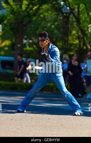 Rockabilly dancing male in vintage full jean outfit and slicked back hair performs to rock and roll music weekly at Yoyogi park Stock Photo