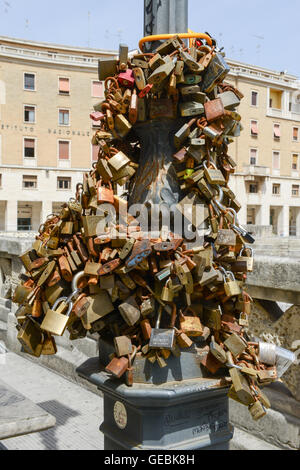Metal padlocks hanging on a pole at Lecce in Puglia, Italy Stock Photo