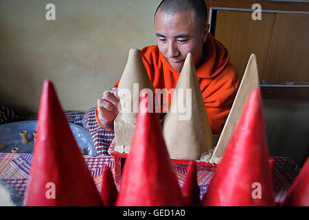 Monk making offerings, in Gaden Shartse monastery.McLeod Ganj, Dharamsala, Himachal Pradesh state, India, Asia Stock Photo