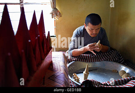 Monk making offerings, in Gaden Shartse monastery.McLeod Ganj, Dharamsala, Himachal Pradesh state, India, Asia Stock Photo