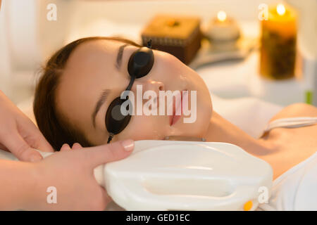 Beautiful woman getting laser hair removal at beauty salon Stock Photo