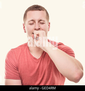 Man is yawning on a white background. Toned photo. Stock Photo