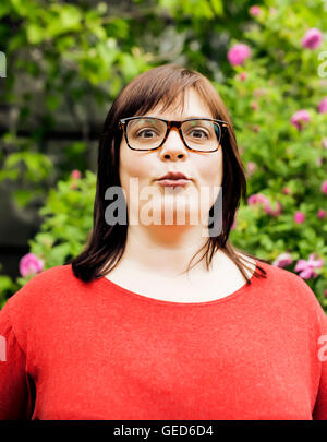 pretty modern mature fat woman outside wearing glasses, emotional
