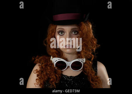 Beautiful woman with red hair wearing top hat Stock Photo