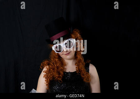 Beautiful young woman wearing vintage black sequin tank top, top hat and goggles, Stock Photo