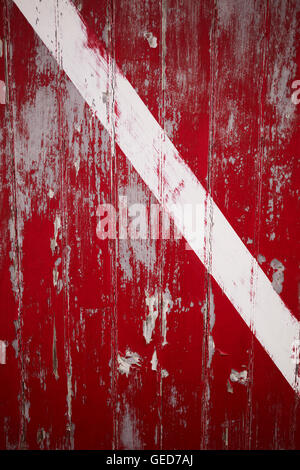 Weathered red door with white stripe in Memensha Massachusetts on Martha's Vineyard Stock Photo
