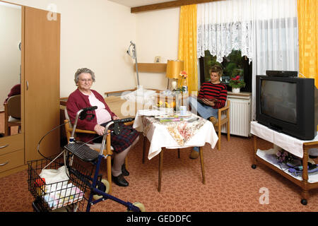 Elderly woman visited by her grandson at a nursing home Stock Photo