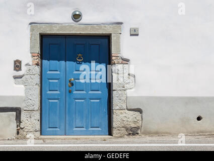 Blue wooden front door to the house in Italy Stock Photo