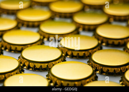 many yellow bottle caps on white background Stock Photo