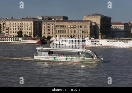 Duna Bella City Cruises boat speeds downstream on warm summer afternoon Stock Photo