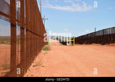 The border between Naco, Arizona, USA and Naco, Sonora, Mexico is indicated by a metal wall, as seen from Arizona. Stock Photo