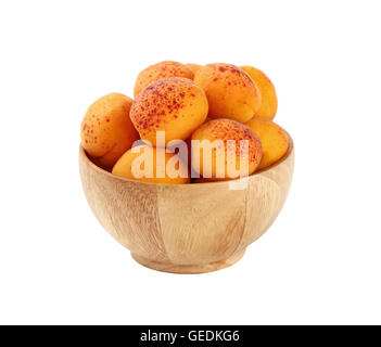 Mellow ripe fresh apricots with in small wooden bowl isolated on white background, close up Stock Photo