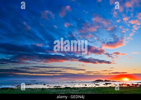 geography / travel, Canada, Newfoundland, Sunset with beautiful clouds above a jagged rocky island off shore from the town of L'Anse aux Meadows, Northern Peninsula, Newfoundland Labrador, Stock Photo