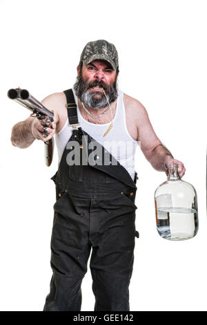 Angry hillbilly with shotgun and moonshine on a white background. Stock Photo