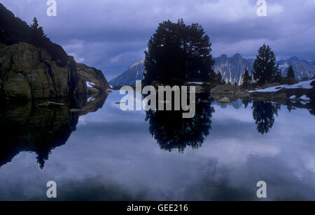 One of the Amitges lakes, in background view of Els Encantats peaks,Aigüestortes i Estany de Sant Maurici National Park,Pyrenees Stock Photo