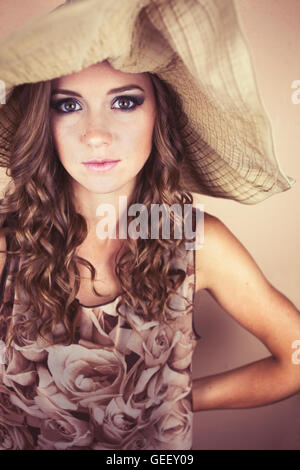 Beautiful young woman wearing big sun hat Stock Photo