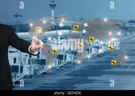Businessman working with virtual interface to control connection networks of airplanes on their destination routes. Stock Photo