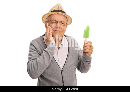 Mature man experiencing a tooth ache from eating ice cream isolated on white background Stock Photo