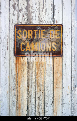 Weathered Sign: Sortie de Camions - Trucks output. Stock Photo