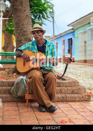 Cuban street musician busking and playing guitar in Trinidad, Cuba Stock Photo