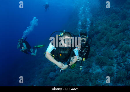 Scuba divers in blue water, Red sea, Egypt Stock Photo