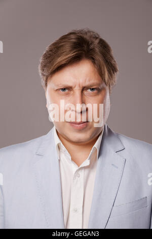 Angry Frowning Middle Age Man in Blue Jacket Stock Photo