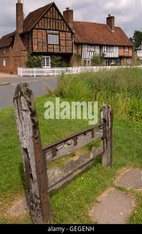 The old village stocks Manor House & Pond Aldbury Hertfordhire UK Late June