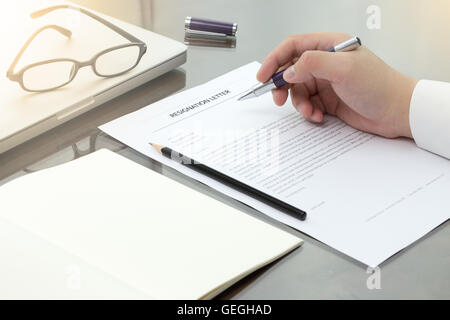 Resignation letter information with pen, pencil and glasses. Stock Photo