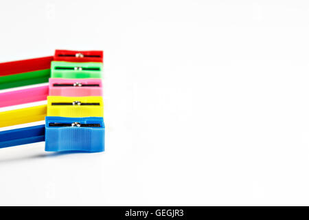 Colored pencils and sharpener on white background. Horizontal image. Stock Photo