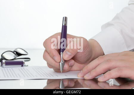Businessman working on his desk with hand holding pen reflection. Stock Photo