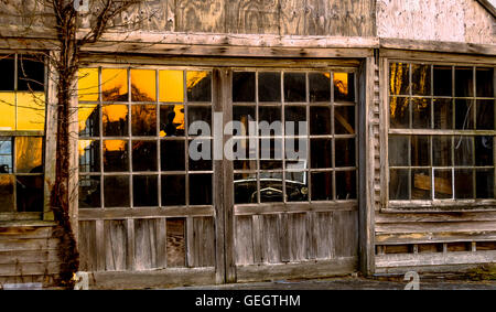 Early automotive dealership, with 1920's Ford inside, at sunset. Stock Photo