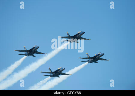 Four United States Navy Blue Angels F/A-18 Hornets flying in formation. Stock Photo