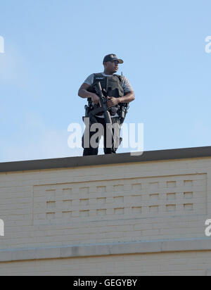 African American police officer in tactical gear watches over a police rally in High Springs, Florida. Stock Photo