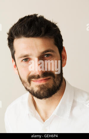 Portrait of a bearded man smiling at the camera. Stock Photo