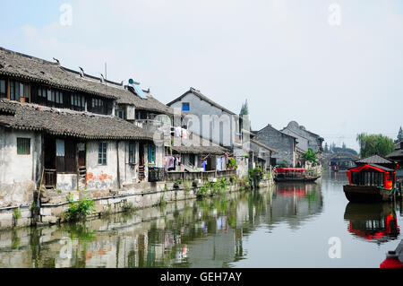 The old and weathered buildings lining the water canals of Fengjing Town in Shanghai China. Stock Photo