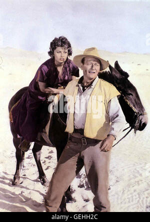 Sophia Loren, John Wayne   Dita (Sophia Loren) schliesst sich einer Expedition von Joe (John Wayne) und Paul Bonnard an. Die beiden suchen die Schaetze einer versunkenen Stadt in der Sahara. *** Local Caption *** 1957, Legend Of The Lost, Die Stadt Der Ve Stock Photo