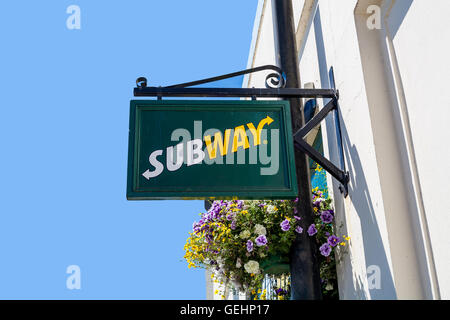 TRURO, CORNWALL, UK - JULY 17, 2016: Subway store sign on white wall with blue sky. Truro high street fast food outlet. Stock Photo