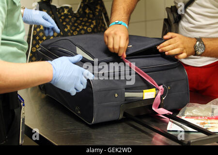 Schkeuditz, Germany. 14th July, 2016. Customs officers search passengers' luggage during a routine check at the Leipzig-Halle Airport in Schkeuditz, Germany, 14 July 2016. Customs officers in Saxony report success in the fight against the trade of protected animals and plants. Photo: SEBASTIAN WILLNOW/dpa/Alamy Live News Stock Photo