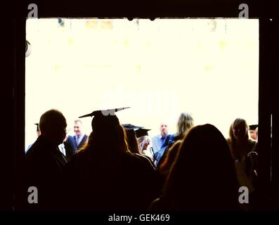 Brighton, UK. 25th July, 2016. A Brighton University graduate wearing the traditional mortar board and cloak leaves the graduation ceremony. Credit:  Graham Hardy/Alamy Live News Stock Photo