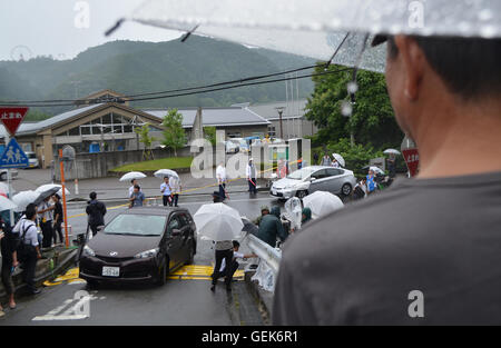 Tokyo, Japan. 26th July, 2016. Members of the press, residents and local officials stand in front of Tsukui Yamayuri-en care center in Sagamihara City, Kanagawa prefecture Japan. Early that day 26-year-old Satoshi Uematsu used several knives to killed 19 people and wounded 25 others. According to a local newspaper, Uematsu gave himself up to police around 15 minutes after staff from the care center have alerted authorities. Credit:  ZUMA Press, Inc./Alamy Live News Stock Photo