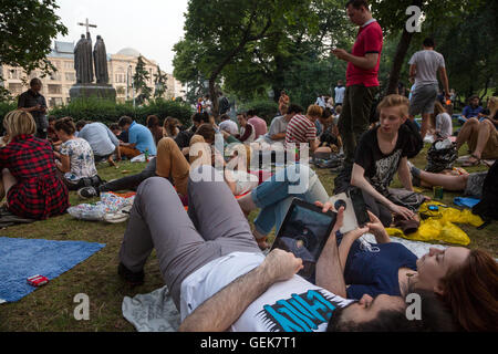 Moscow, Russia. 26 of July, 2016. Young people play Pokemon Go from Nintendo on their mobile devices in Ilyinsky Park in central Moscow, Russia Credit:  Nikolay Vinokurov/Alamy Live News Stock Photo