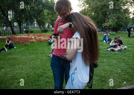 Moscow, Russia. 26 of July, 2016. Young people play Pokemon Go from Nintendo on their mobile devices in Ilyinsky Park in central Moscow, Russia Credit:  Nikolay Vinokurov/Alamy Live News Stock Photo