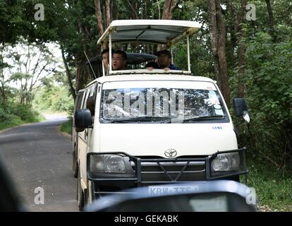 (160727) -- NAIROBI, July 27, 2016 (Xinhua) -- Chinese tourists visit by van at the Nairobi National Park in Nairobi, capital of Kenya, July 26, 2016. Kenya has recorded minimal wildlife attacks on humans inside parks and game reserves thanks to solid measures that include enhanced vigilance and public outreach, an official said on Tuesday.  (Xinhua/Li Baishun) (wjd) Stock Photo