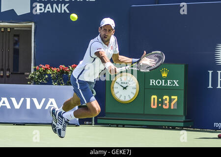 Toronto, Canada. 27th July, 2016. NOVAK DJOKOVIC of Serbia and Montenegro returns the ball to Giles Muller of Luxembourg during their second round match of the Rogers Cup tournament at the Aviva Centre. © Joao Luiz De Franco/ZUMA Wire/Alamy Live News Stock Photo