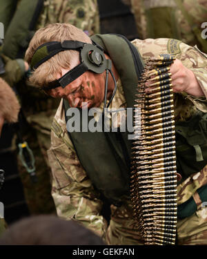 A Royal Marine Commando prepares a belt of 7.62mm ammunition for a GPMG (General Purpose Machine Gun). Stock Photo