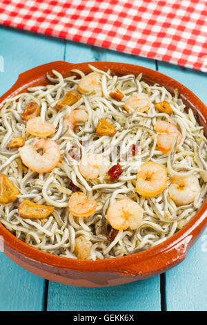 Surimi elvers with prawns, garlic and pepper in a traditional earthenware dish Stock Photo