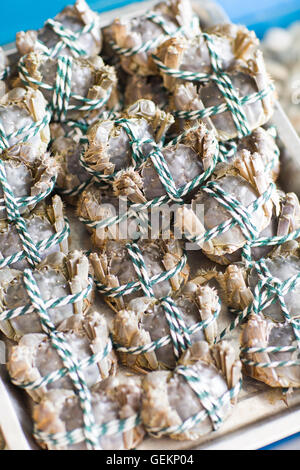 Hairy crabs wrapped in straw for sale Stock Photo