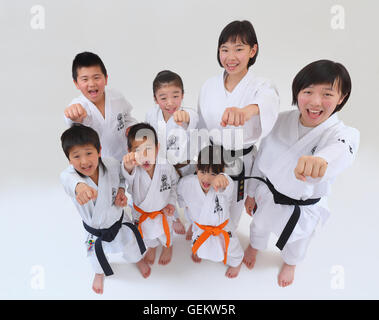 Japanese kids in karate uniform on white background Stock Photo