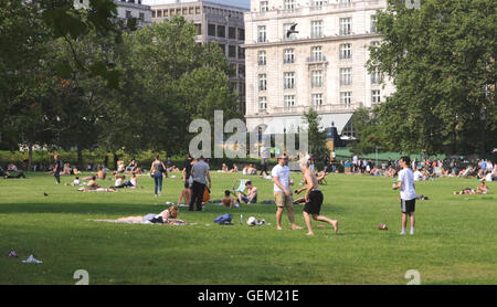 People relaxing in Green Park Piccadilly London in the July 2016 heatwave